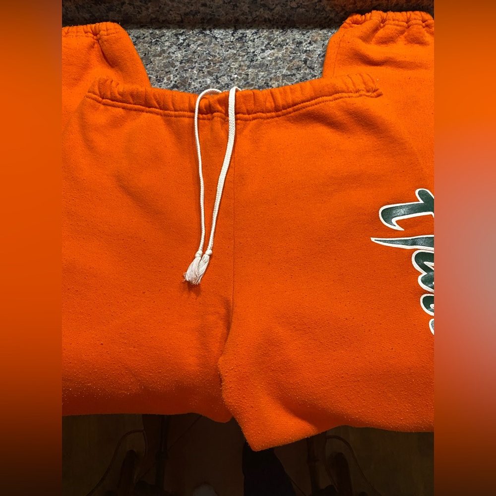 MIAMI HURRICANES sweatpants. Size M. Orange with Hurricanes logo